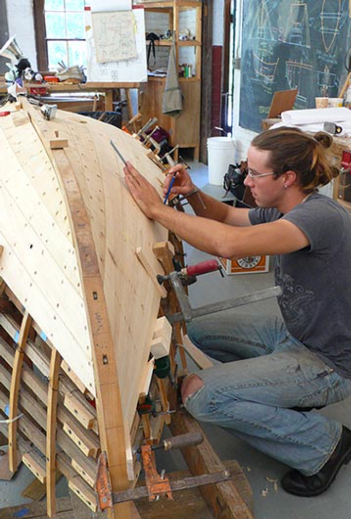 Fundamentals of Boatbuilding at WoodenBoat School student working on planking